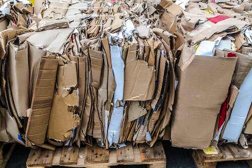 Cardboard boxes in tightly compressed bales.